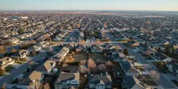 Suburban neighborhood with diverse homes, representing the breadth of federal housing policy impact.