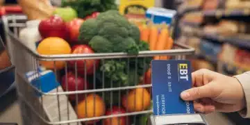 EBT card being swiped at grocery store checkout with fresh produce