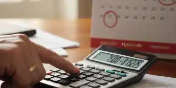 Calculator showing numbers with 2026 calendar, representing Social Security COLA planning.