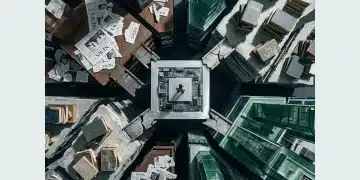 An aerial view of a fragmented city diorama built from newspaper clippings, textbooks, green glass, and circuit boards, representing disconnected news, education, benefits, and finance streams, with a lone human figure symbolizing confusion.