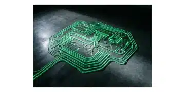 Overhead view of a person's hands adjusting glowing green fiber optic cables representing interconnected news, education, benefits, and finance pathways on a dark circuit board.